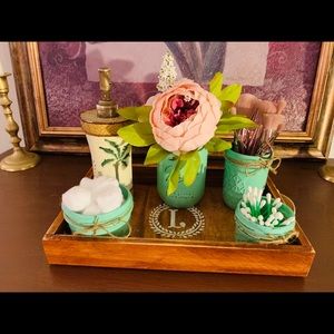 Mason jar bathroom set with a flower.